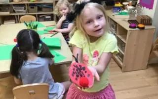 nursery child showing her ladybird