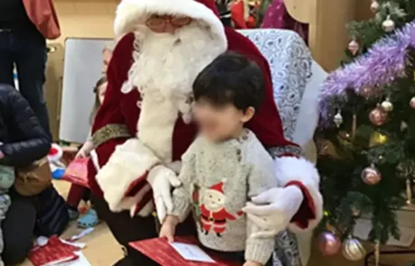 Nursery child getting present from santa