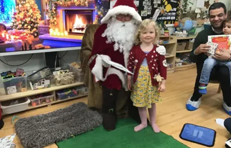 Nursery child meeting Santa